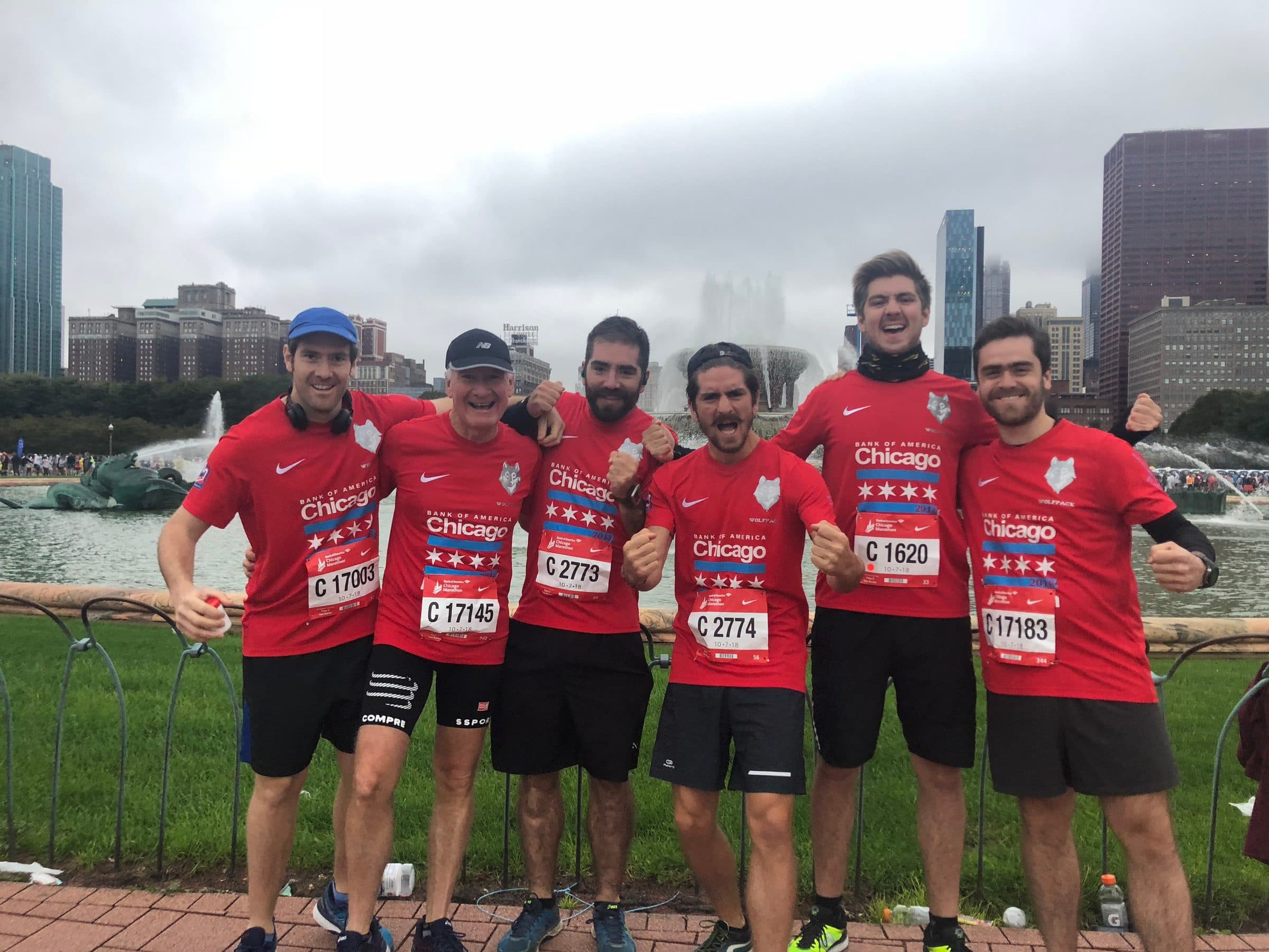 Los seis corredores con camisetas rojas de Chicago y sus dorsales, junto al río.