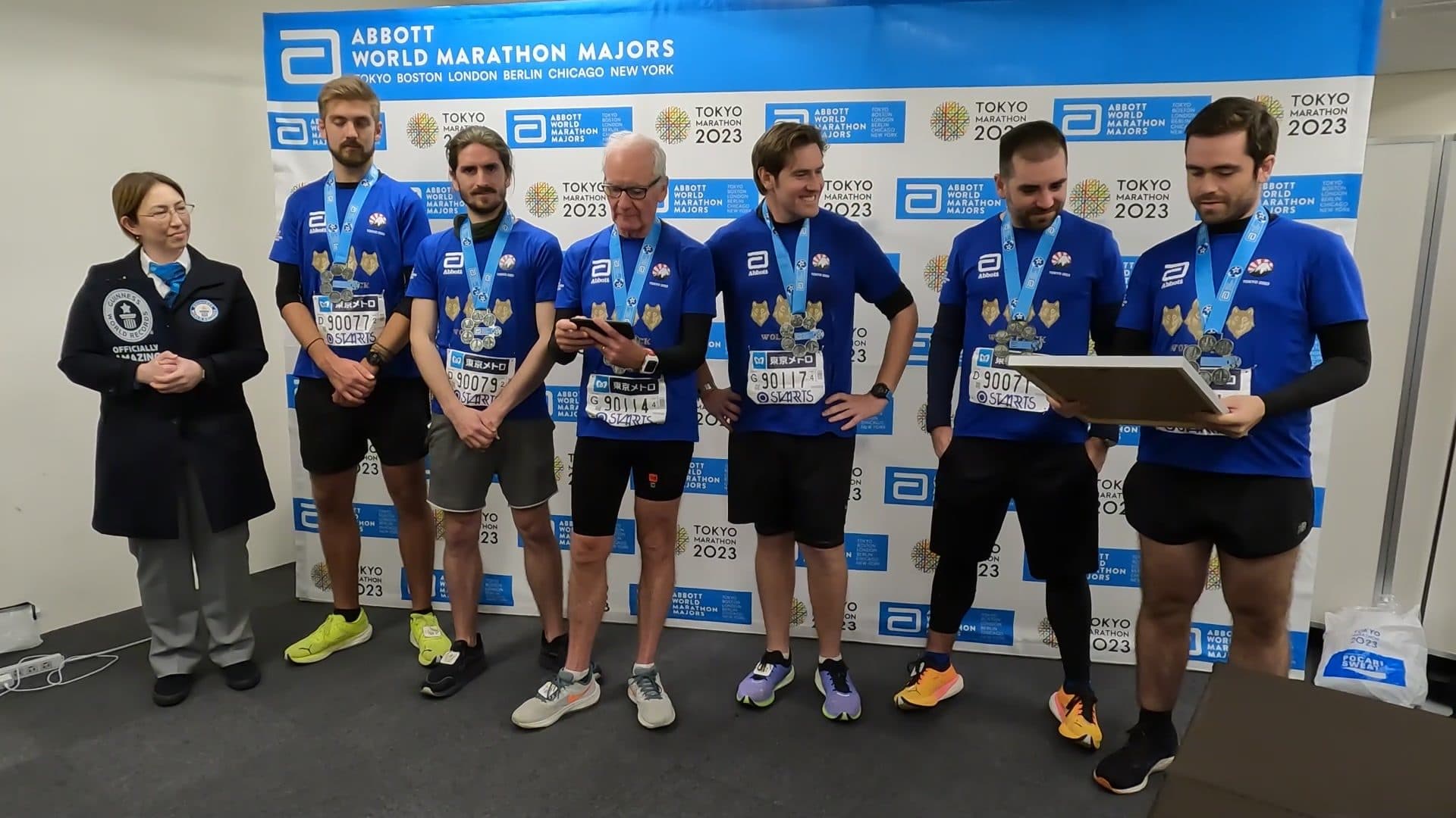 The six with their medals, the Guinness World Records adjudicator and the certificate, Tokyo 2023