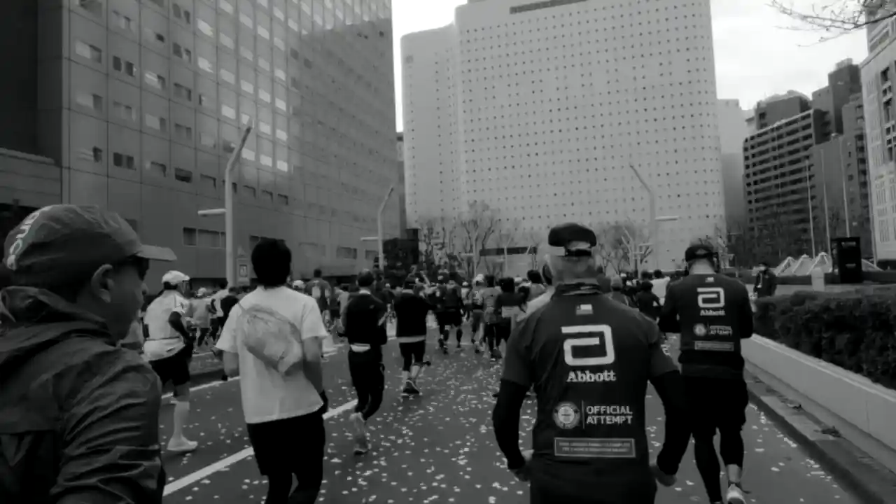 Wolfpack runners from behind on the Tokyo Marathon course, 2023